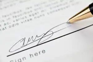 Timing your hiring of a Fairfax or Virginia criminal lawyer - Picture of contract and pen