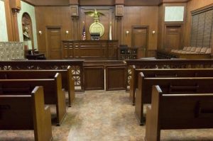Photography of courtroom with wooden benches