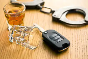 Talking with police in Virginia DUI cases- Image of keys, alcohol and handcuffs