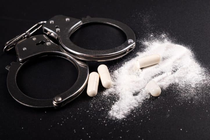 Virginia drug prosecutions- photo of handcuffs and drugs